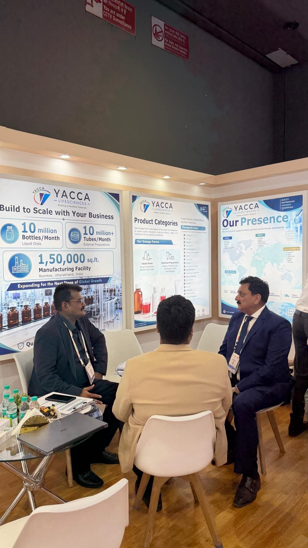 Yacca Lifesciences team in discussion with a visiting partner at the booth